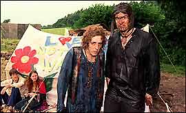 A pair of very muddy people