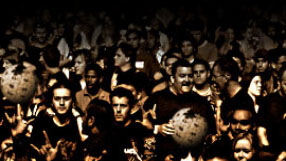 A crowd of people, one holding a Wikipedia globe