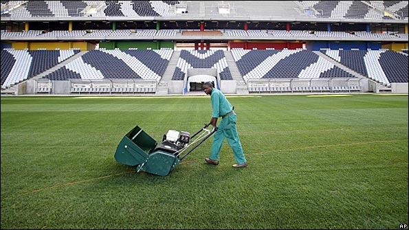 Worker mows the pitch at Mbombela Stadium, South Africa