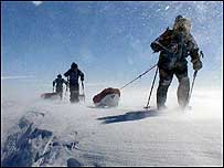 The team hauling their sledges in strong winds