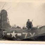 Here is Bill, guarding a 2 engine fighter bomber that has crashed.