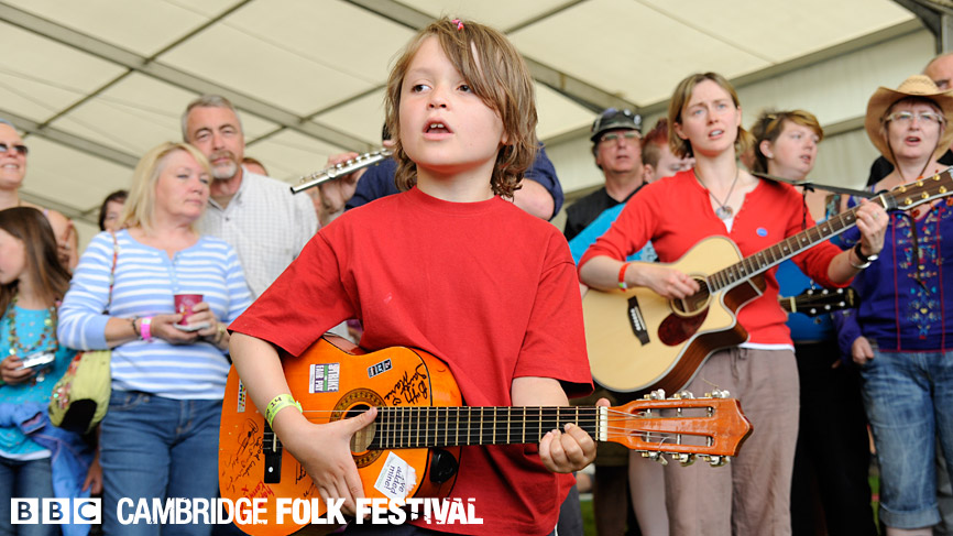 An 8-year old folk fan was one of the first to arrive and promptly plant himself at performer Jon's feet!