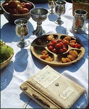 Table spread with goblets, tankards and fruit