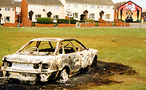 Burnt out car in the Lower Shankill area of Belfast