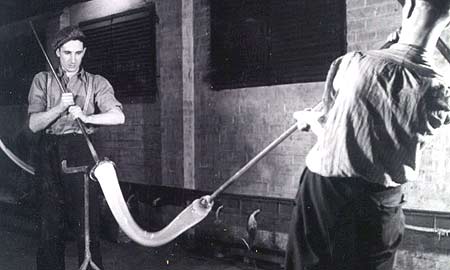 Workers shaping glass
