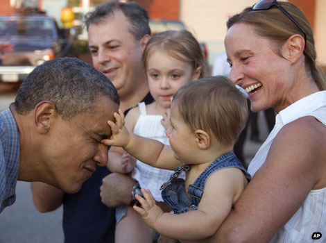 A baby touches the face of US president Barack Obama.