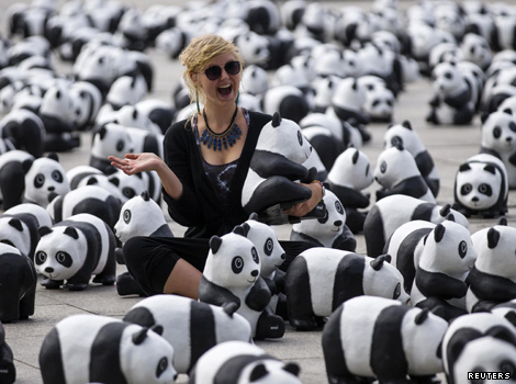 Woman surrounded by pandas