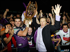 Melbourne Storm captain Cameron Smith (L) holding the National Rugby League (NRL) trophy aloft with coach Craig Bellamy (R) on 30 September 2007