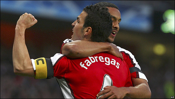 Arsenal's Cesc Fabregas and Theo Walcott celebrate