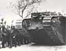A crowd of soldiers welcome a tank as it returns from its first time in action