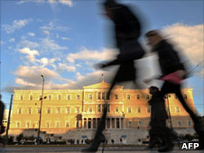 People walk past Greek parliament building