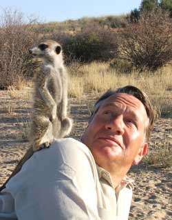 Michael with meerkat on his shoulder