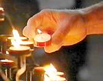 Candles lit in church during Christian prayer