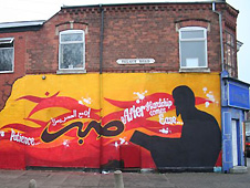 Orange and yellow mural on side of shop wall