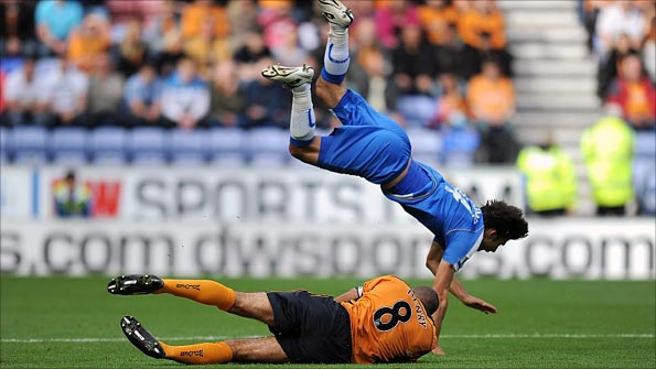 Jordi Gomez is felled by Karl Henry