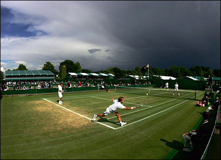 Another dark cloud hangs over SW19 as a men's doubles match takes place