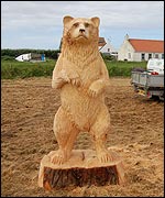 Bear carved from wood by chainsaw