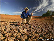 An Australian stockman surveys the bottom of a dry dam on his drought-hit property