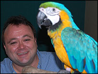 Toby Foster with a parrot