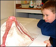 Christopher watches as his volcano erupts!