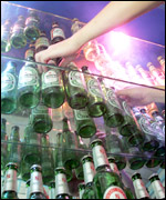 Bottles of alcohol lined up in a bar