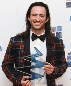 Aaron Sillis poses with The Times Breakthrough Award the South Bank Show Awards 2009. (Photo: Getty Images)