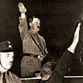 Adolf Hitler salutes his followers at a Nazi Party rally soon after his appointment as Chancellor. © United States Holocaust Memorial Museum (USHMM)