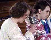 A member of the congregation drinking communion wine