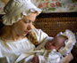 Natalie Press holding a baby, from BBC One's Bleak House