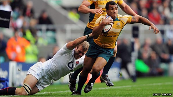 Australia scrum-half Will Genia weaves away from England flanker Tom Croft.jpg