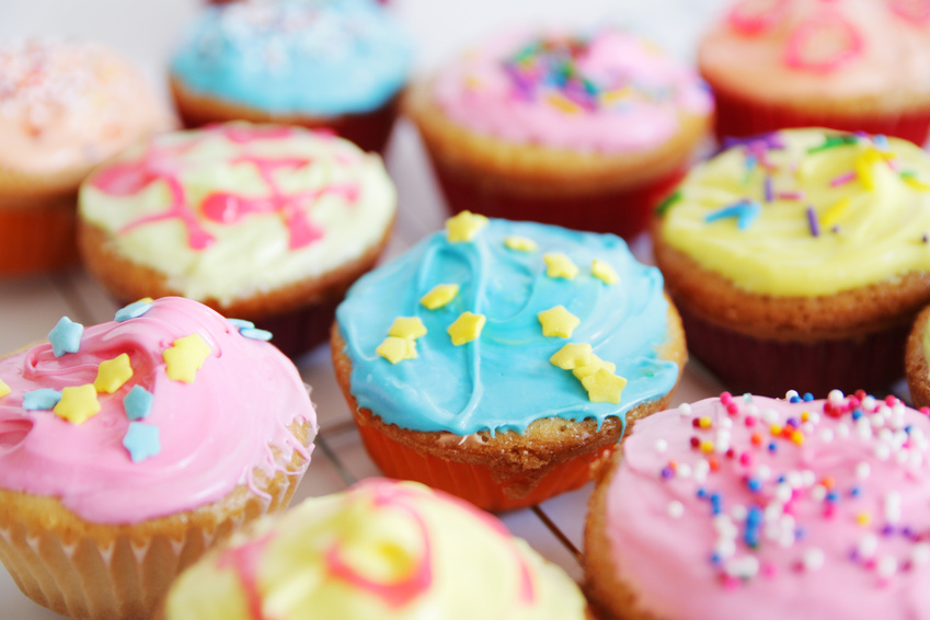 colored cup cakes @ pink candy - fotolia.com