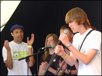 Phil King (l) watches his singing group perform