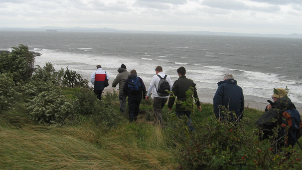 group of walkers beside the sea