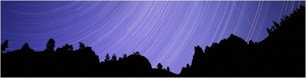 Time exposure photograph of polar stars during a meteor shower. The circular streaks of light result from the rotation of the Earth in relation to the fixed stars. The diagonal line across the trails is the track of a Perseid meteor. Photographed over the rim of Nicola River canyon, British Columbia, Canada, in August.