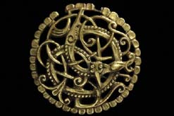 The Pitney Brooch; An entwined animal and snake in combat. (c) The British Museum