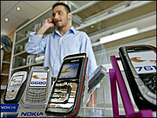 Iraqi man browsing mobile phones