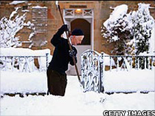 Man clearing his pathway of snow