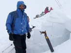 Mountaineer beginning to dig snow-hole (Image courtesy of John Armstrong, Glenmore Lodge)