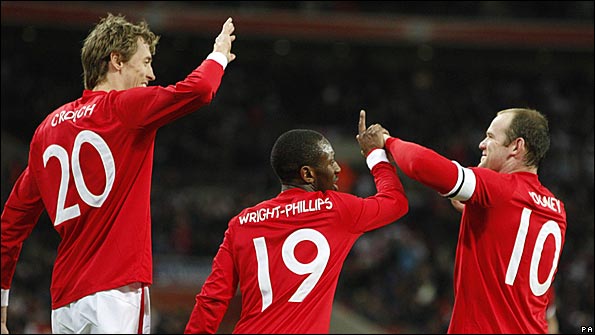 Crouch celebrates with Shaun Wright-Philips and Wayne Rooney