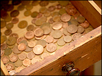 Copper coins in a wooden drawer