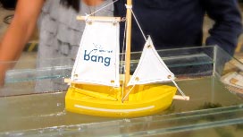 A toy boat in a water tank