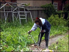 Amie tidies up an overgrown garden
