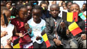 Pupils of the Belgium school of Kinshasa wait for the arrival of King Albert II of Belgium, his wife the Queen Paola, and the Belgium Prime Minister Yves Leterme on June 29, 2010