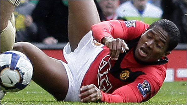 Antonio Valencia goes down under challenge from Javier Mascherano