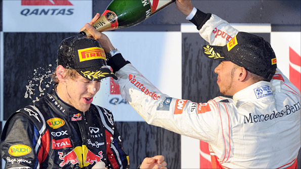 Australian Grand Prix winner Sebastian Vettel is sprayed with champagne by runner-up Lewis Hamilton