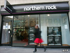 Woman walking past Northern Rock branch