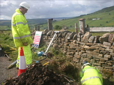 Workmen laying fibre pipes