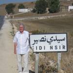 Jonathan Wilkinson returns to Sidi Nsir on 3rd November 2005 thanks to 'Heroes Return'. In the far background is the memorial to the battle fought on 26th February 1943.