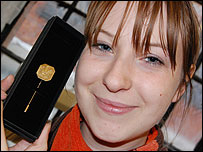 Lora with the pin she has designed for Prince Charles