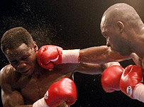 Nigel Benn lands a punch on Chris Eubank